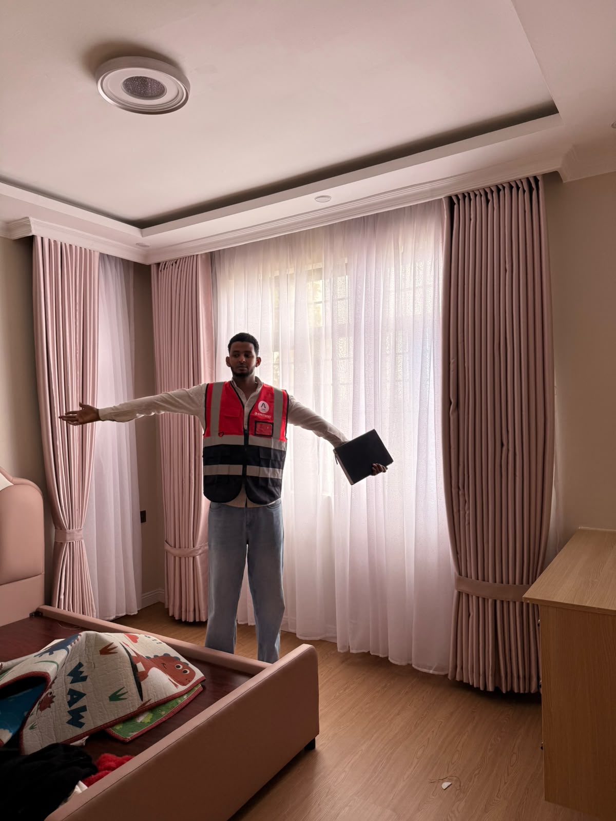 Abdii Finest Curtains installer fitting custom bedroom curtains in Nairobi
